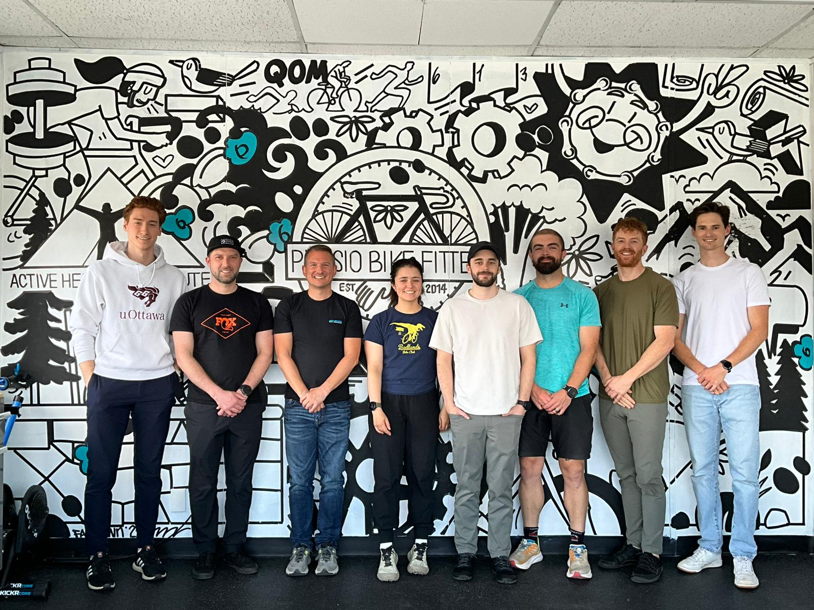 The course group standing together in front of the Physio Bike Fitter mural in Ottawa